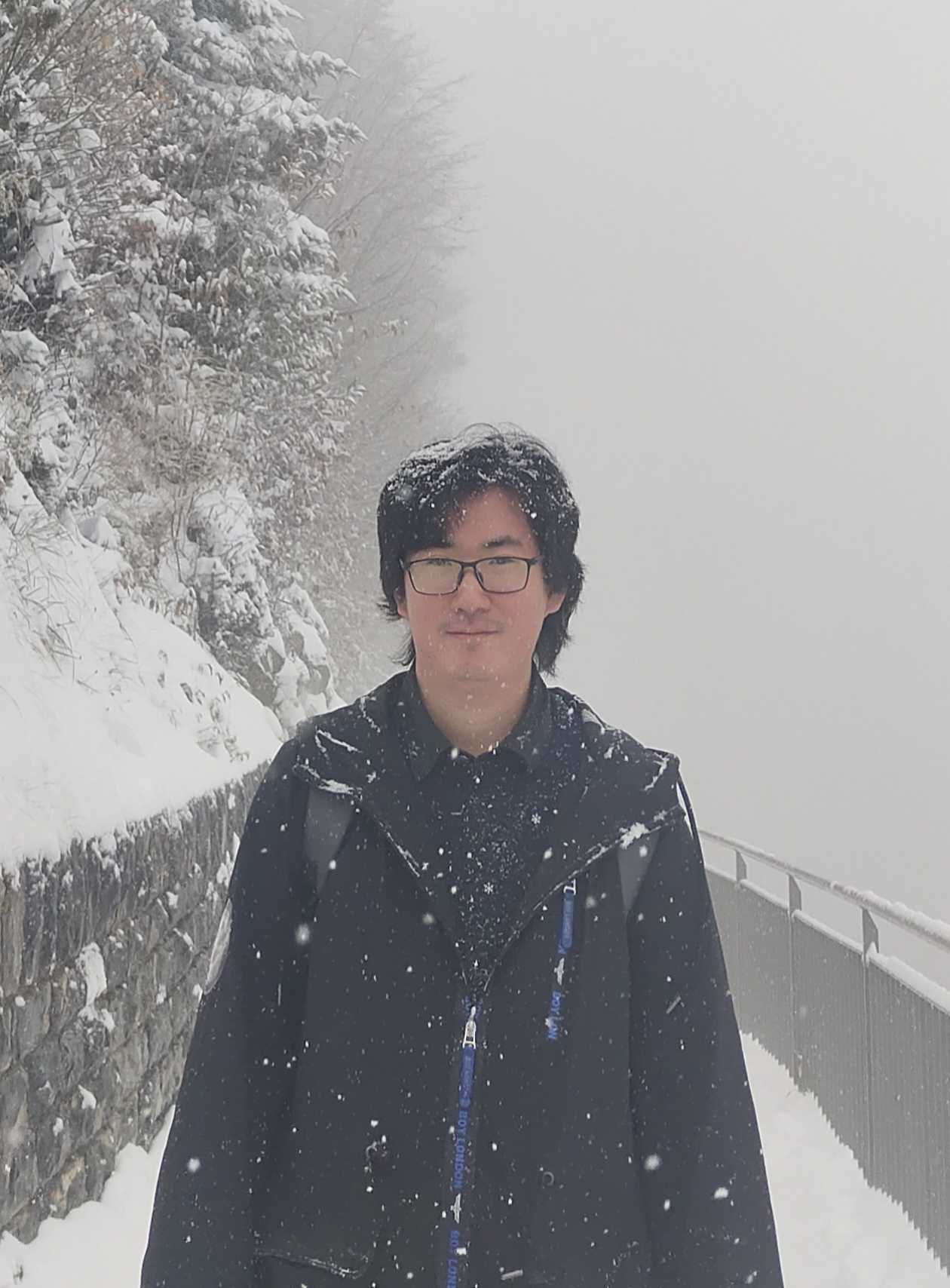 Portrait of Mingyang Song on a snow-covered mountain path.